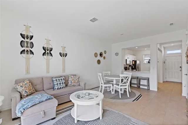 a living room with furniture a rug and a chandelier