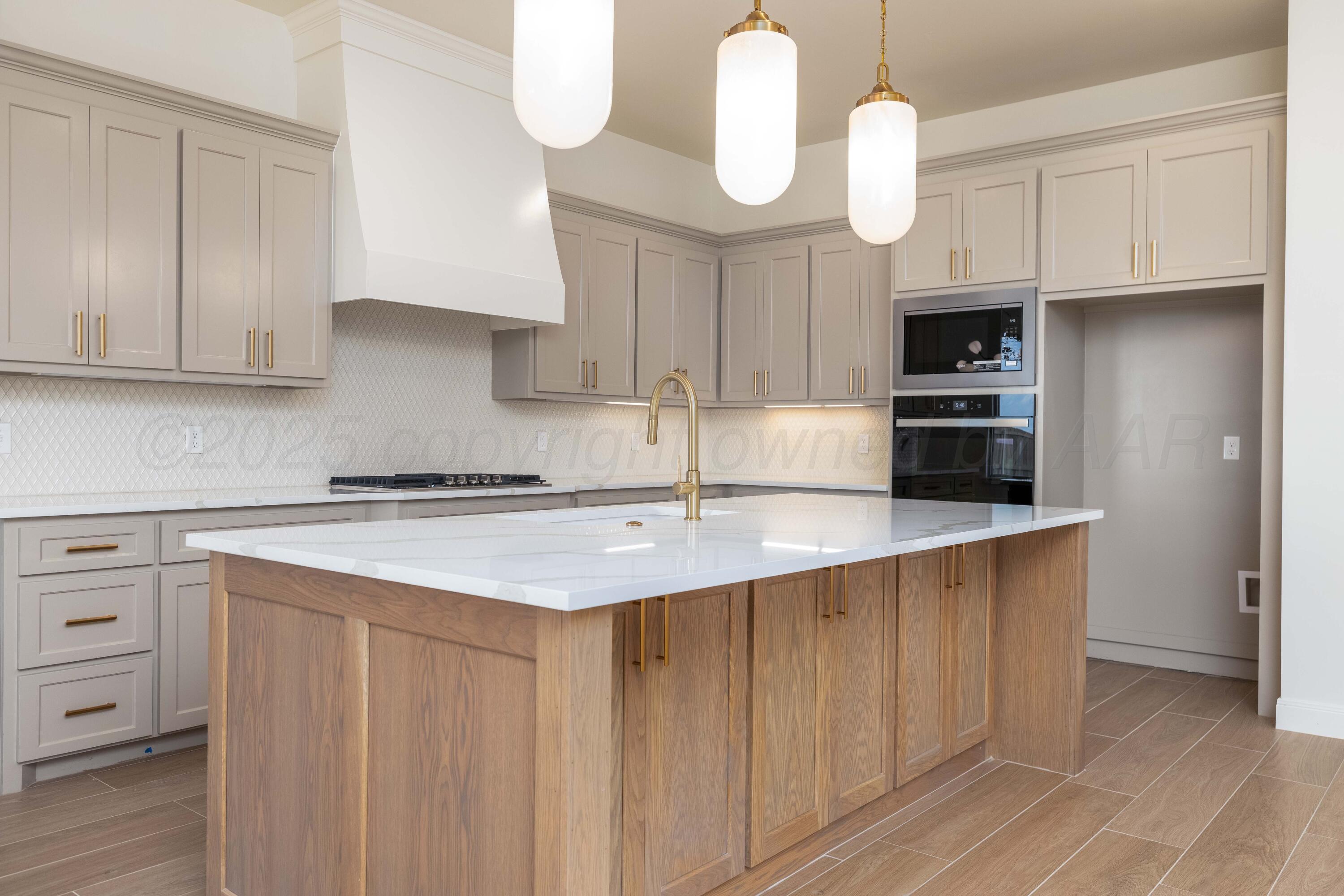 10251 Prickly Pear Road Amarillo, TX 79119 - Photo 14 of 30 a kitchen with stainless steel appliances a sink a stove and cabinets