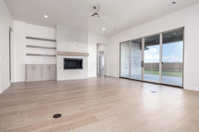 a view of a room with wooden floor and fireplace