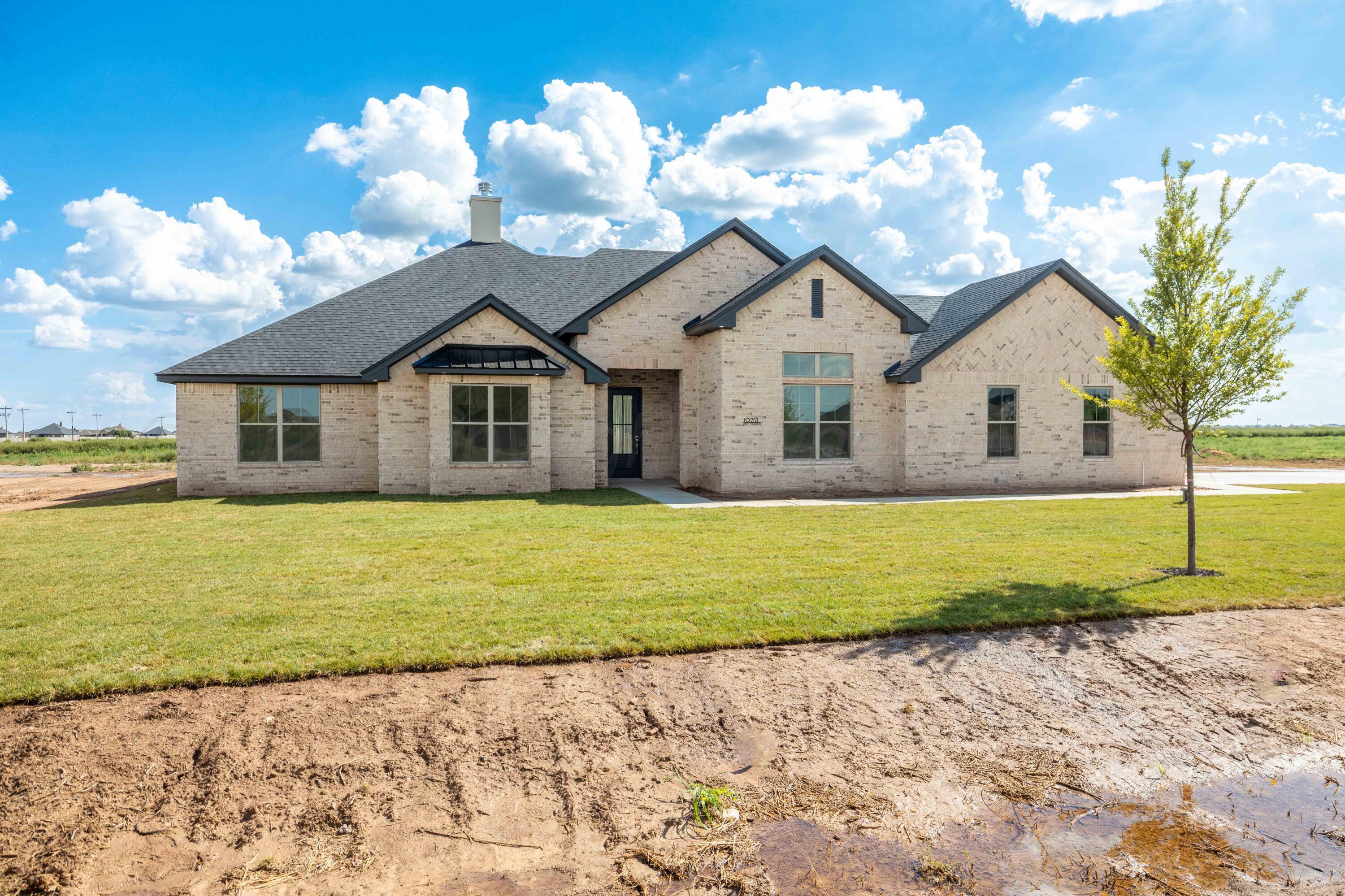 10251 Prickly Pear Road Amarillo, TX 79119 - Photo 2 of 30 a front view of a house with a yard and garage