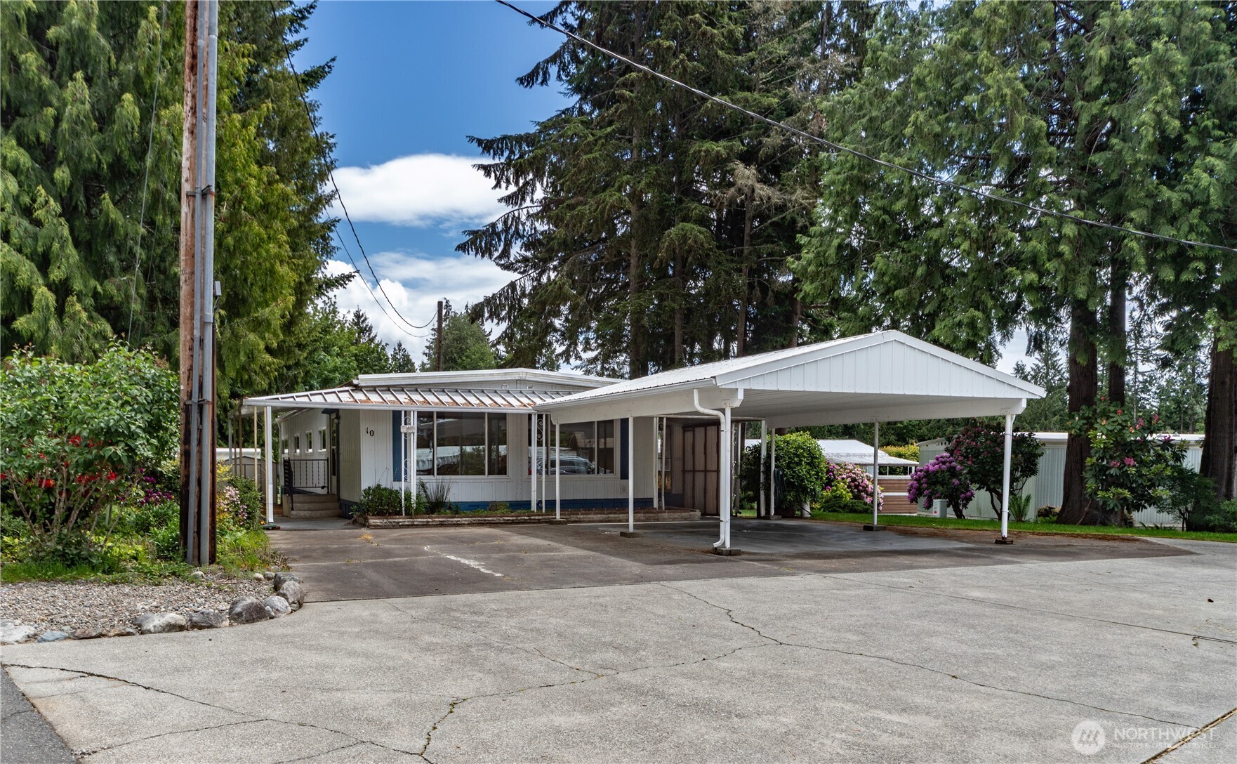 16300 Northeast State Highway, Unit 10 Poulsbo, WA 98370 - Photo 1 of 34 a view of a table and chairs under an umbrella