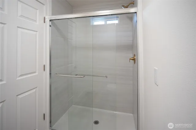 a bathroom with a glass shower door