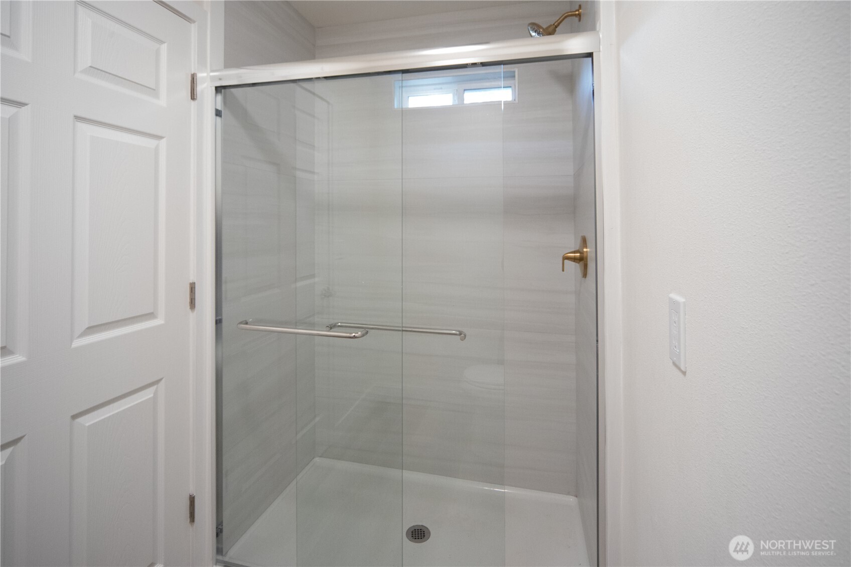 16300 Northeast State Highway, Unit 10 Poulsbo, WA 98370 - Photo 14 of 34 a bathroom with a glass shower door