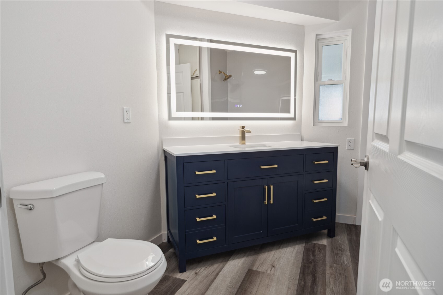 16300 Northeast State Highway, Unit 10 Poulsbo, WA 98370 - Photo 17 of 34 a bathroom with a toilet a sink and mirror
