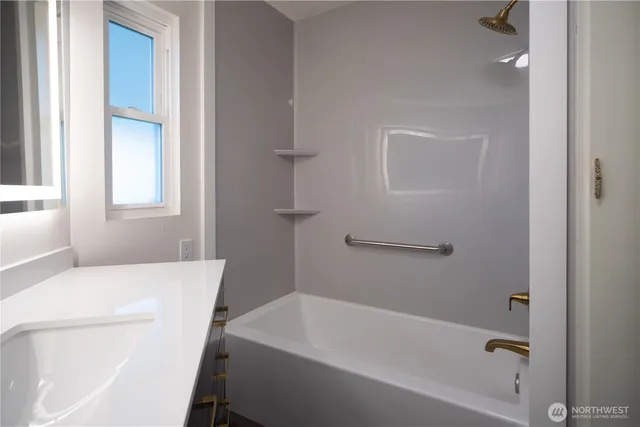 a bathroom with a bathtub and window