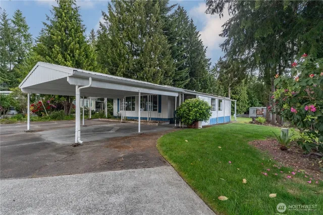 a house with green field in front of it