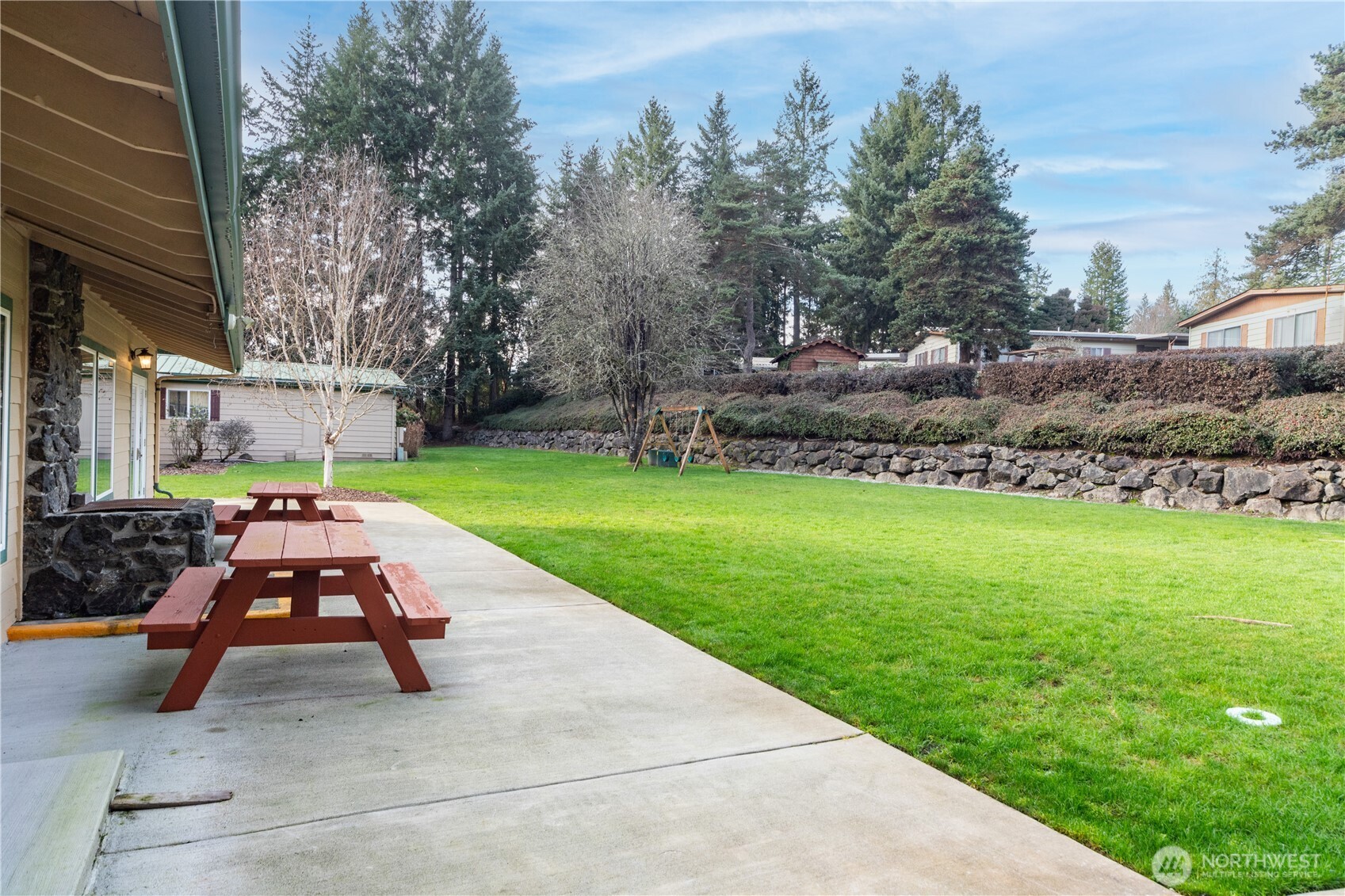 16300 Northeast State Highway, Unit 10 Poulsbo, WA 98370 - Photo 30 of 34 a view of backyard with table and chairs and potted plants