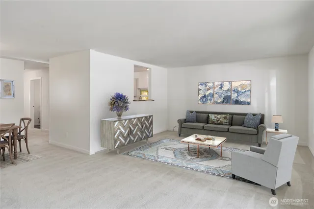 a living room with furniture and a wall painting