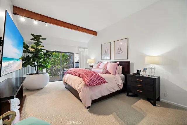 a bedroom with a large bed and a potted plant