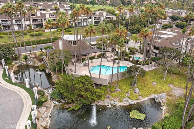 an aerial view of residential houses with outdoor space and swimming pool