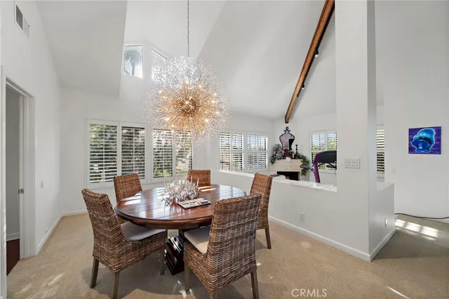 a view of a dining room with furniture and chandelier