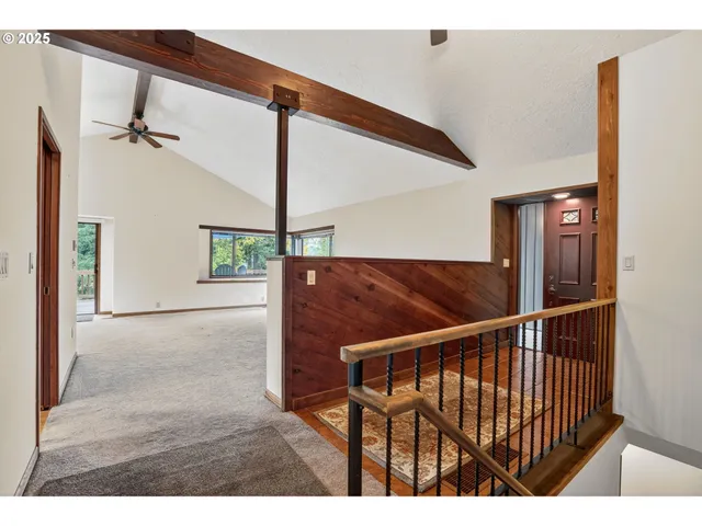 a view of a big room with wooden floor and windows
