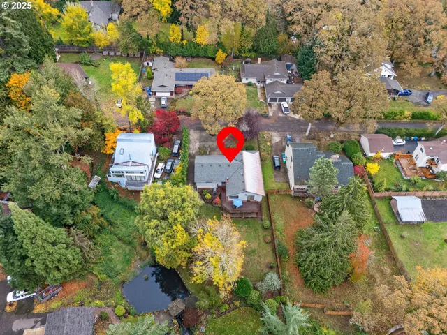 an aerial view of residential house with swimming pool and lawn chairs