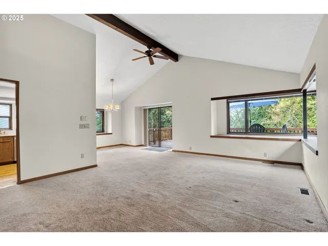a view of an empty room with a kitchen