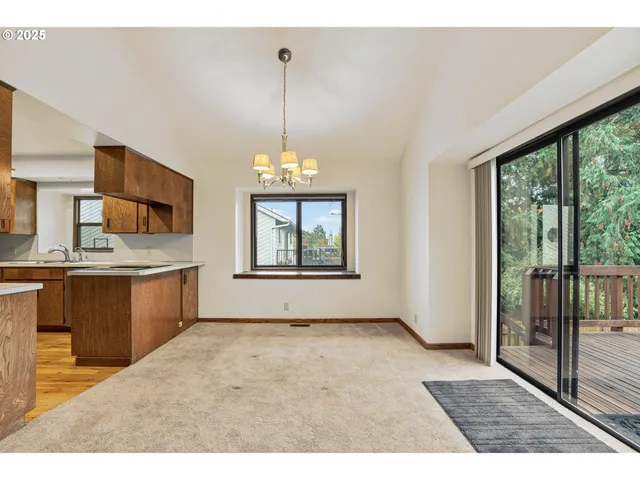 a kitchen with a refrigerator a stove a sink and cabinets