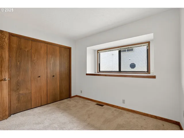 a view of an empty room with closet