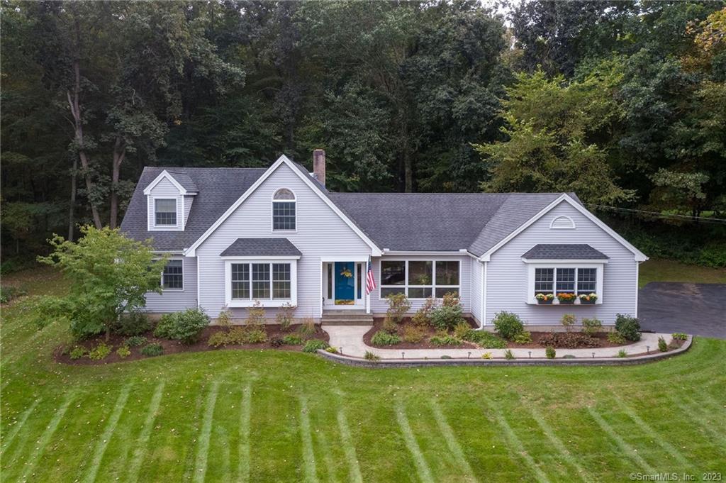 a front view of a house with a yard table and chairs