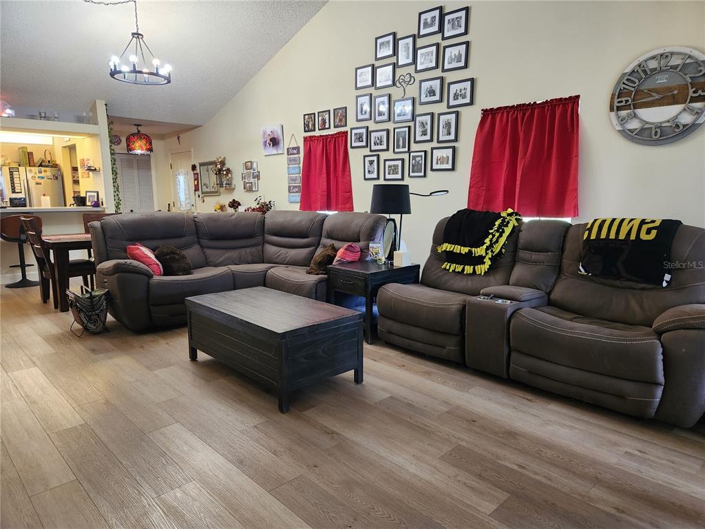 1701 Southeast 24th Road, Unit 1601 Ocala, FL 34471 - Photo 3 of 30 a living room with furniture a couch and chandelier