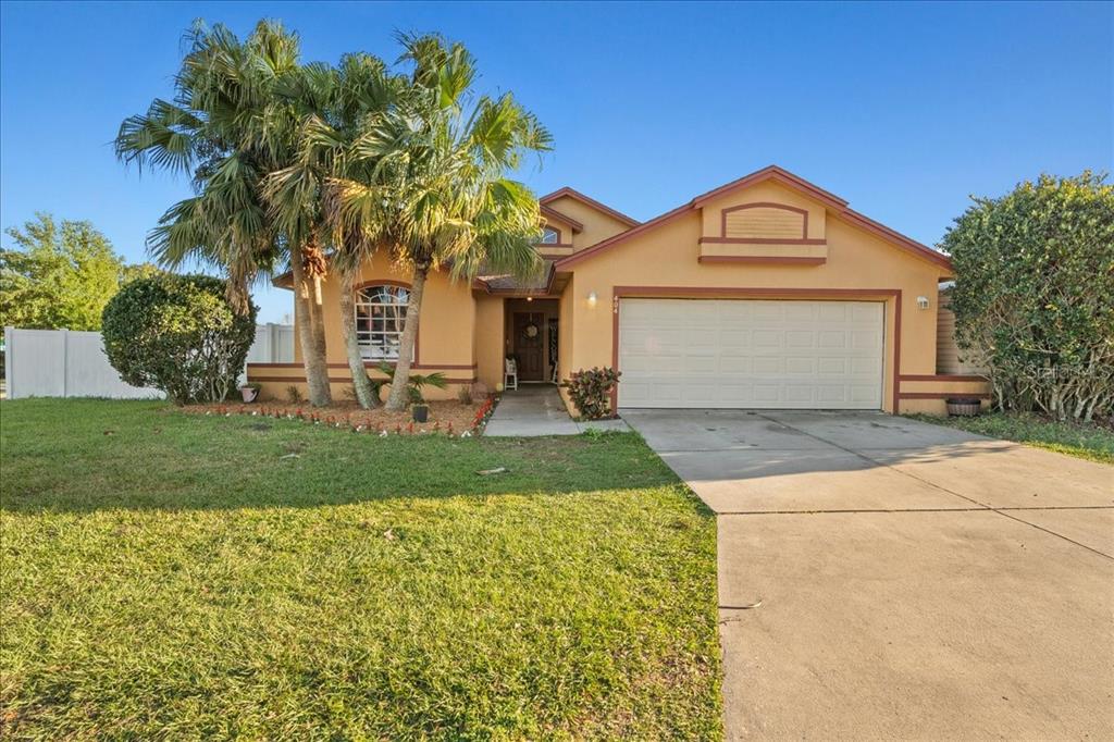 404 Emerald Cove Loop Lakeland, FL 33813 - Photo 1 of 1 a front view of a house with a yard