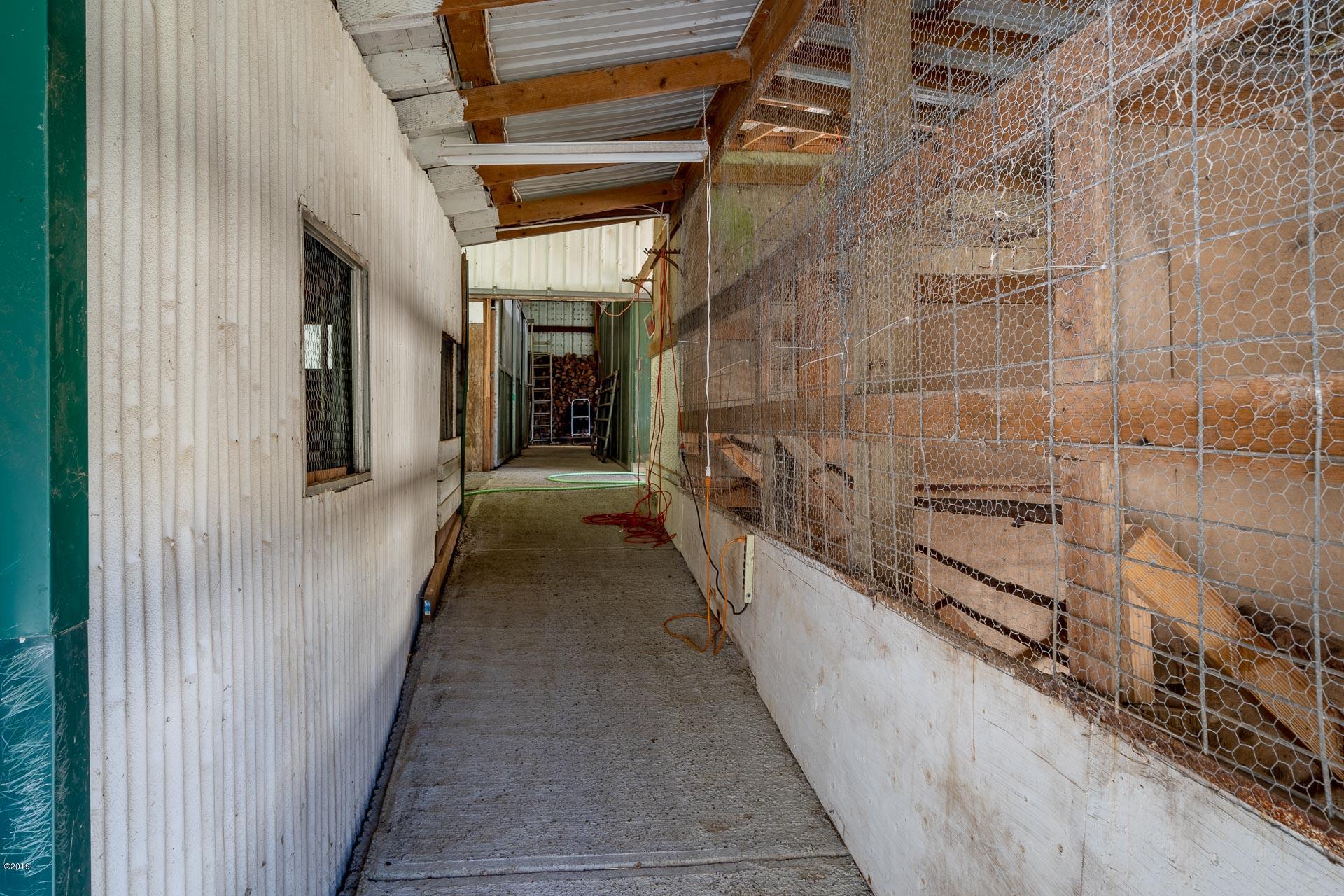 429 Hidden Valley Road Toledo, OR 97391 - Photo 30 of 41 WALKWAY BETWEEN STALLS