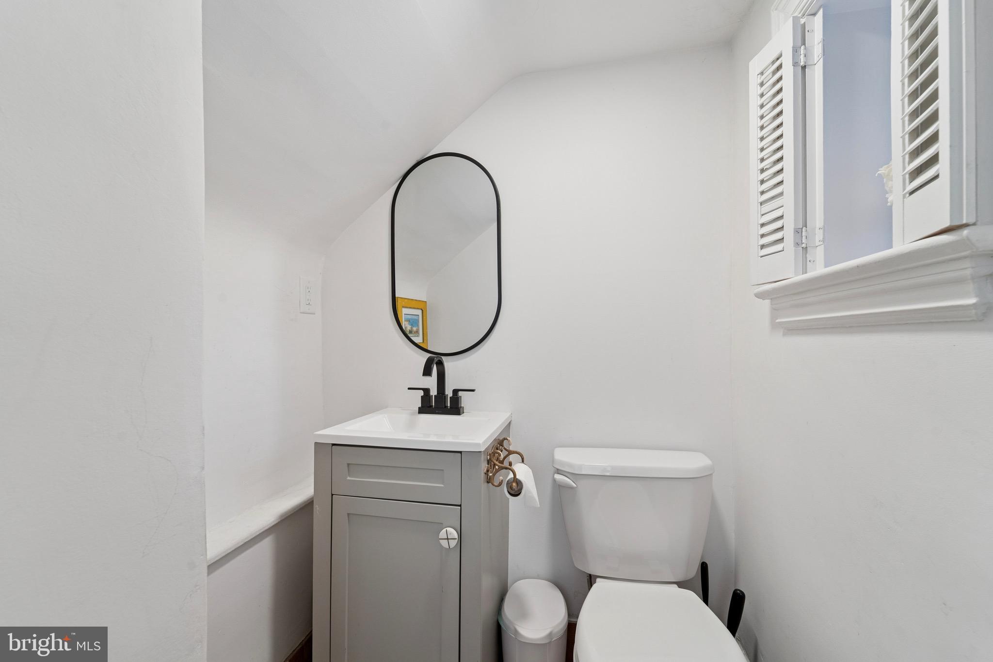 1221 Church Road Wyncote, PA 19095 - Photo 13 of 51 a bathroom with a toilet a sink and a mirror