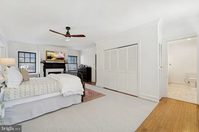 a spacious bedroom with a bed and a flat screen tv