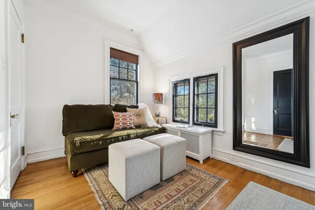 a living room with furniture a rug and a large window
