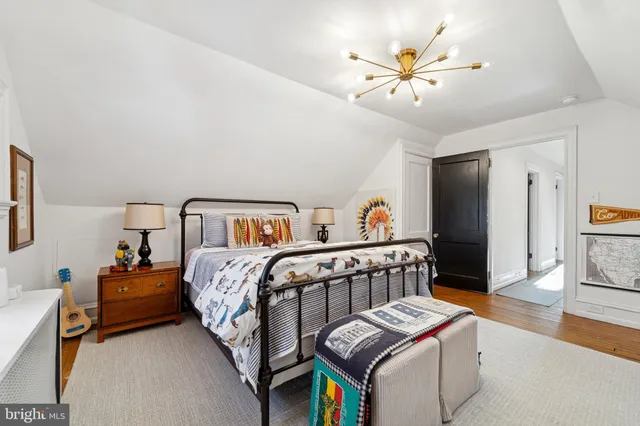 a bedroom with furniture and a chandelier