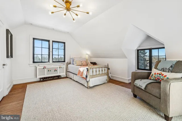 a bedroom with a bed couch and window