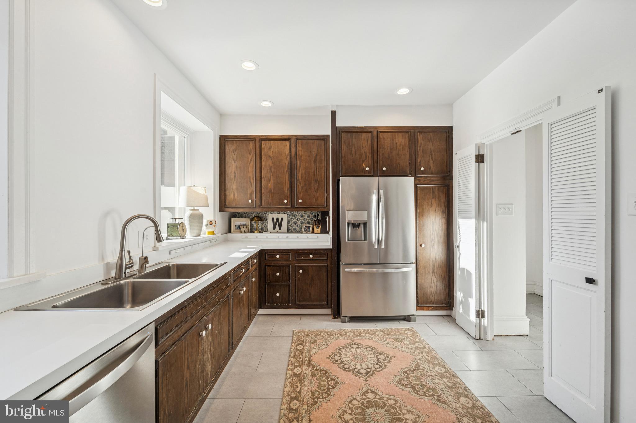 1221 Church Road Wyncote, PA 19095 - Photo 10 of 51 a kitchen with stainless steel appliances granite countertop a refrigerator and a sink