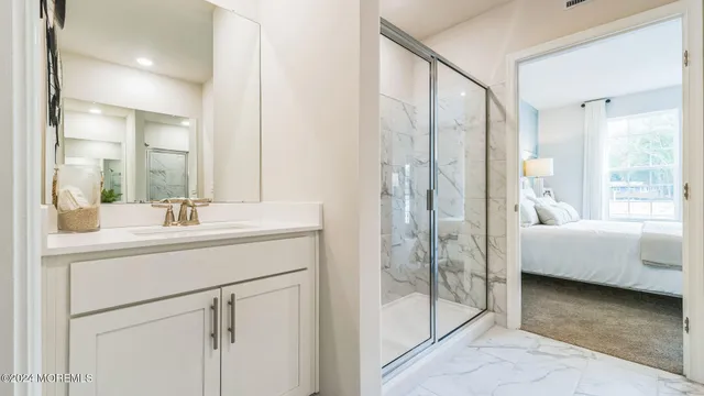 a bathroom with a double vanity sink mirror and shower