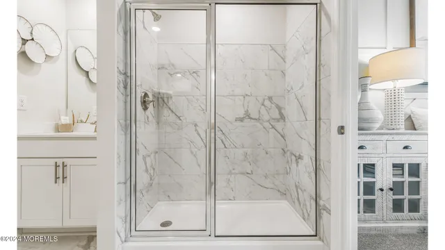a bathroom with a glass shower door