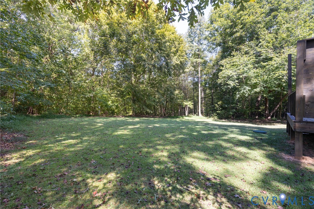 1722 Maidens Road Maidens, VA 23102 - Photo 19 of 21 View of green lawn featuring a forest view