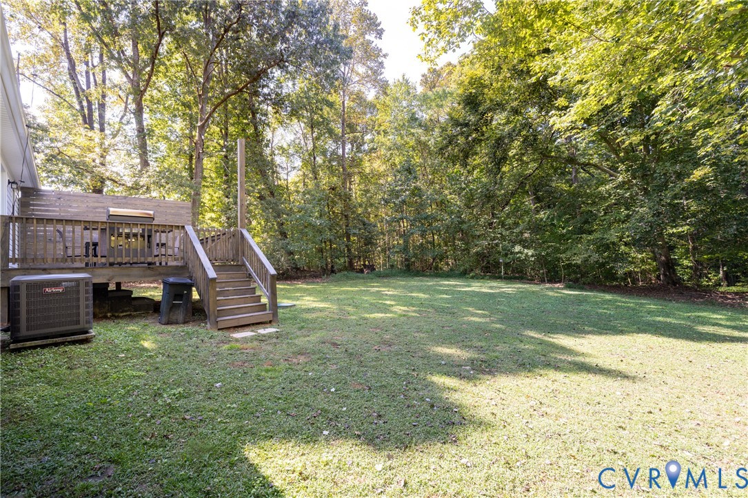 1722 Maidens Road Maidens, VA 23102 - Photo 20 of 21 View of green lawn with a wooden deck and stairway