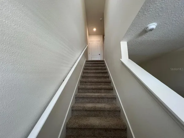 a view of a hallway with stairs