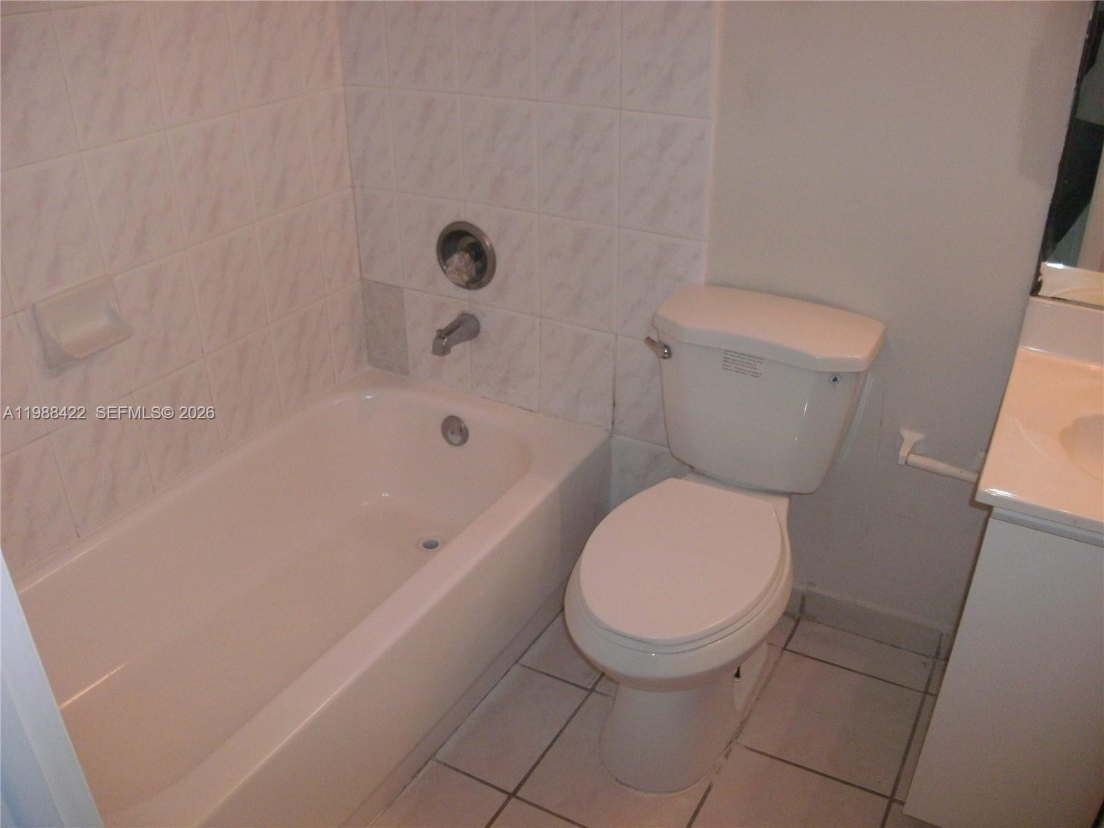 3901 Southwest 109th Avenue, Unit 6 Miami, FL 33165 - Photo 5 of 12 a white toilet sitting next to a bath tub
