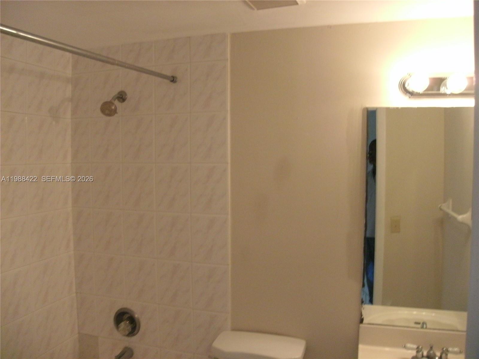 3901 Southwest 109th Avenue, Unit 6 Miami, FL 33165 - Photo 7 of 12 a bathroom with a shower a toilet and a sink