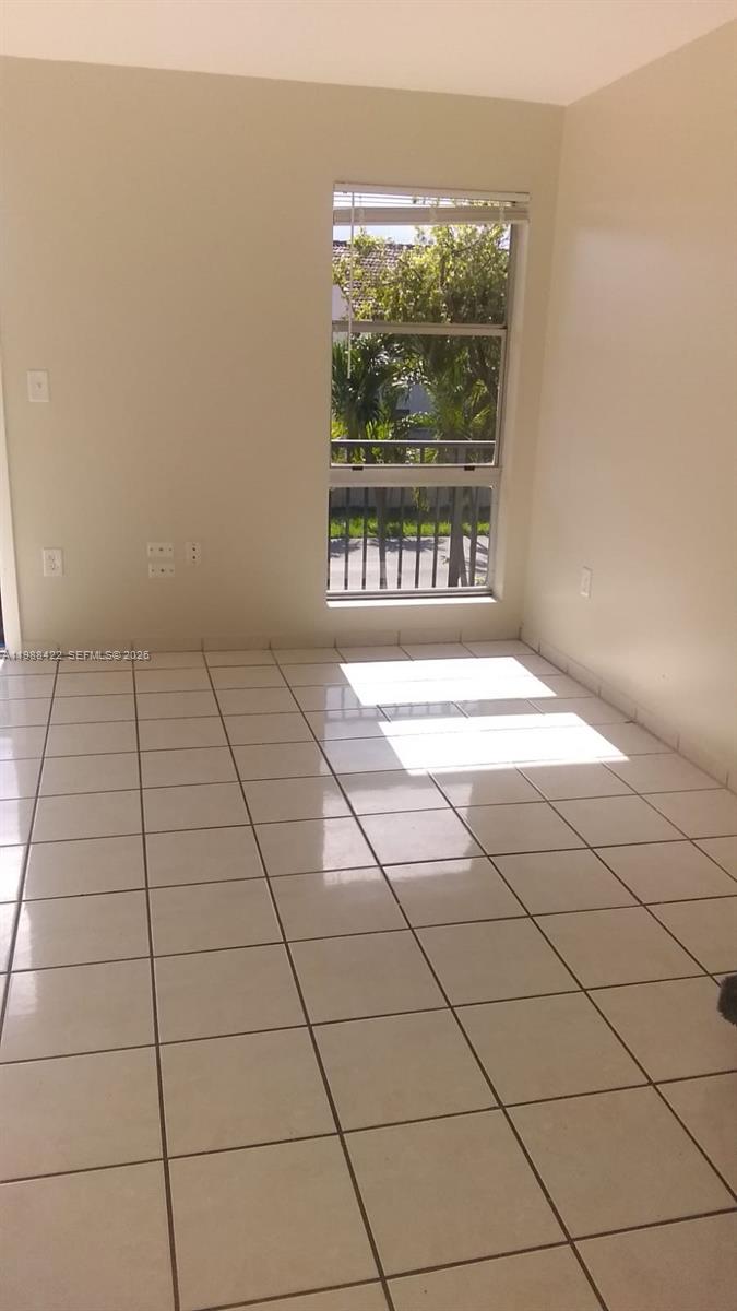 3901 Southwest 109th Avenue, Unit 6 Miami, FL 33165 - Photo 8 of 12 a view of an empty room and window