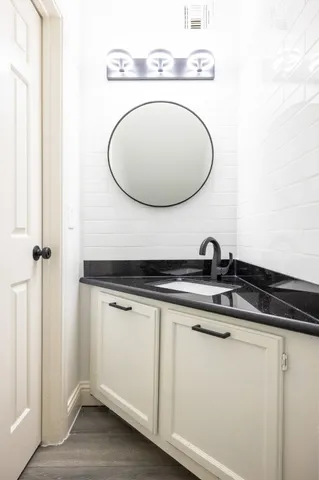a bathroom with a sink and a mirror