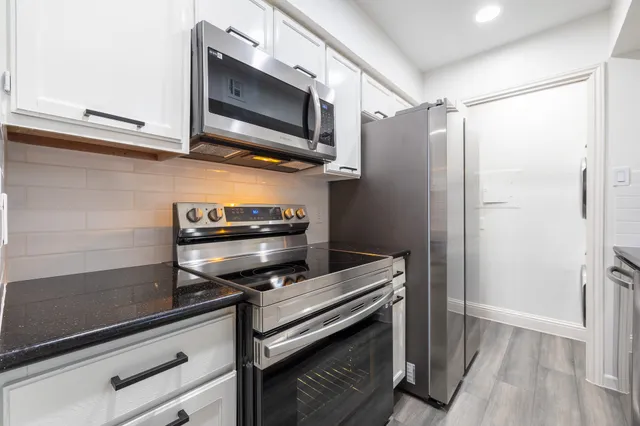a kitchen with a refrigerator stove and microwave