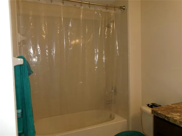 an empty room with closet and a window