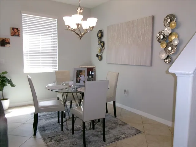 a view of a dining room with furniture and chandelier