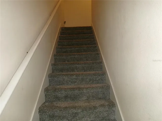 a view of a hallway with bathroom and a sink