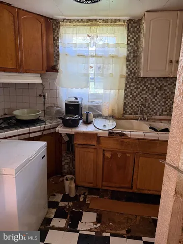 a kitchen with a sink stove and cabinets