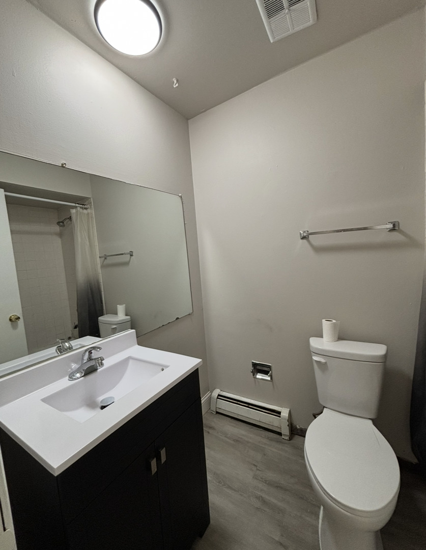 3068 Bernice Avenue, Unit 3S Lansing, IL 60438 - Photo 8 of 8 a bathroom with a toilet sink and mirror