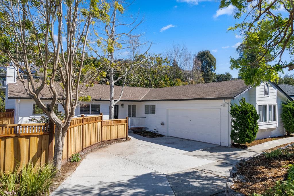 front view of a house with a large tree