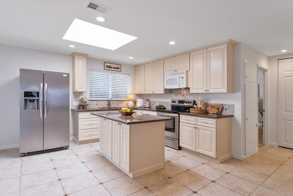135 Baltusrol Drive Aptos, CA 95003 - Photo 12 of 32 a kitchen with stainless steel appliances granite countertop a refrigerator and a stove top oven