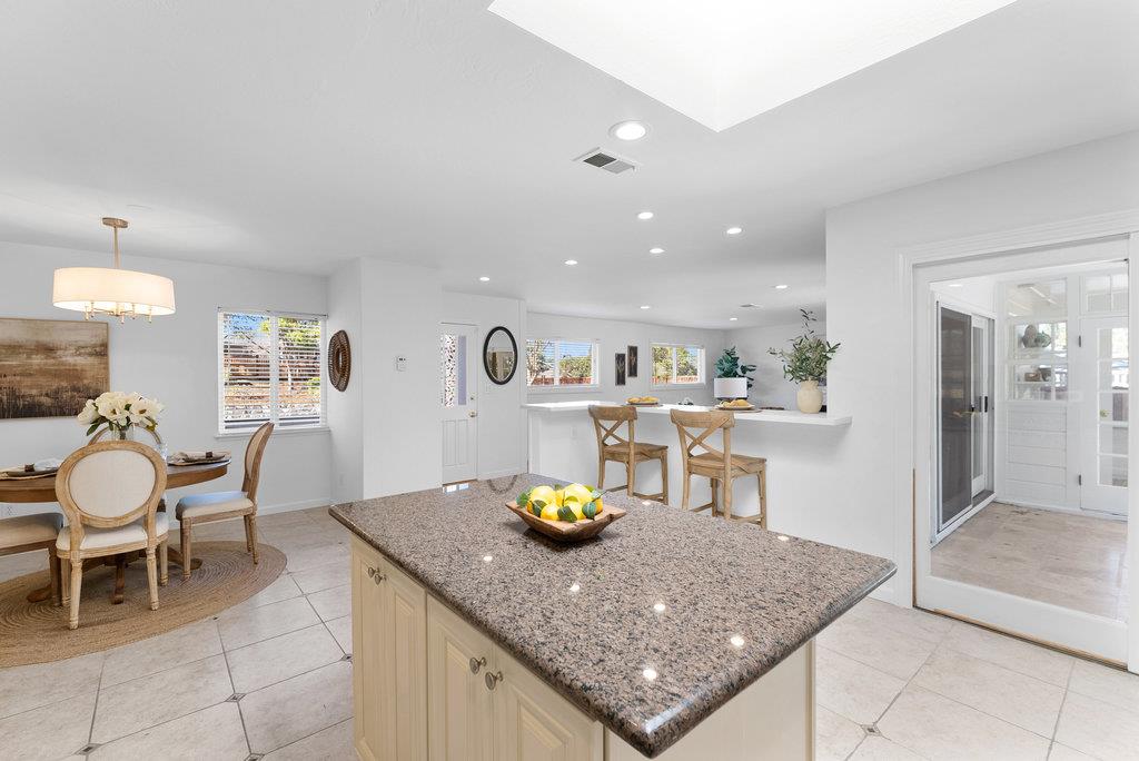 135 Baltusrol Drive Aptos, CA 95003 - Photo 9 of 32 a kitchen with a dining table chairs and sink