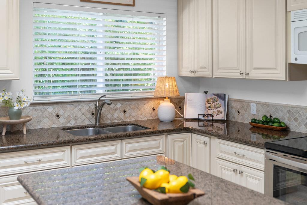 135 Baltusrol Drive Aptos, CA 95003 - Photo 10 of 32 a kitchen with granite countertop white cabinets and a potted plant