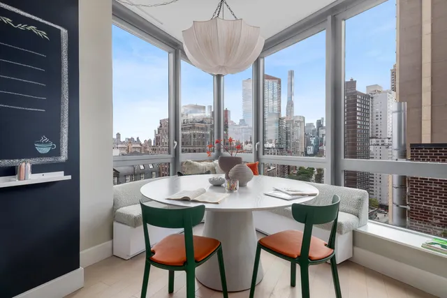 a dining room with furniture a chandelier and window